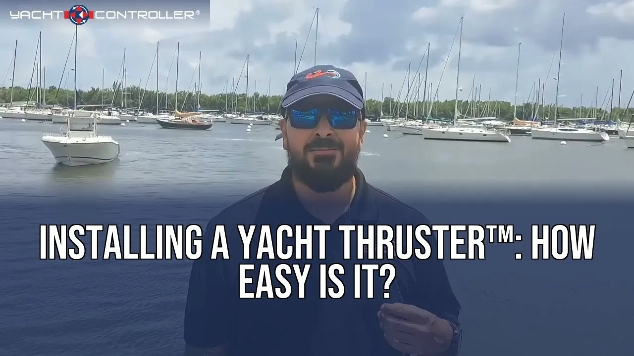 A still from Yacht Thruster's video: a presenter in a cap and sunglasses in front of a mooring field of sailboats, titled Installing a Yacht Thruster, how easy is it?